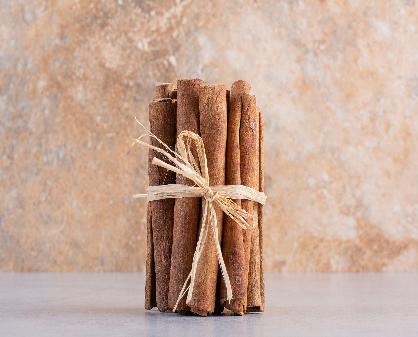Cinnamon sticks isolated on concrete background. High quality photo