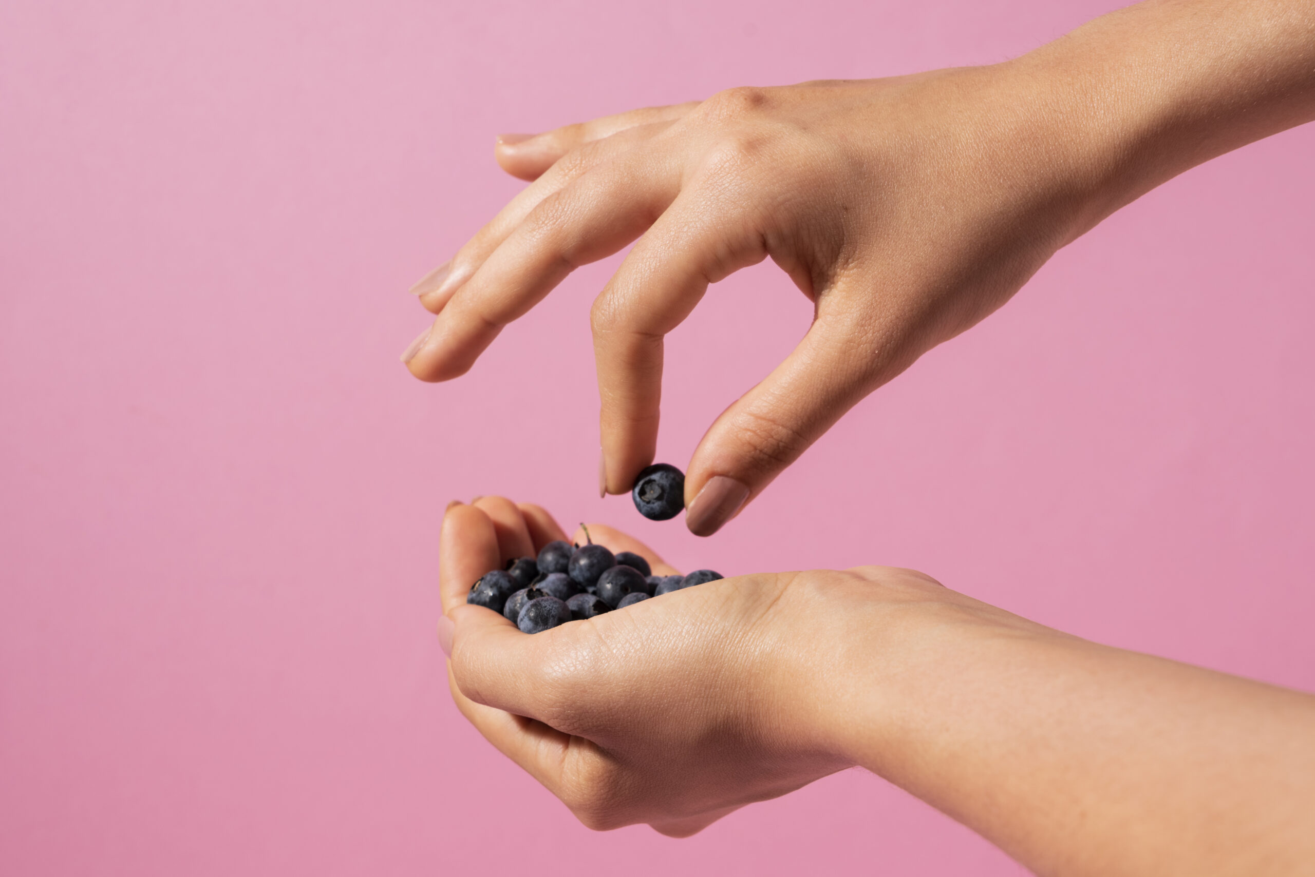 close-up-hands-holding-blueberries